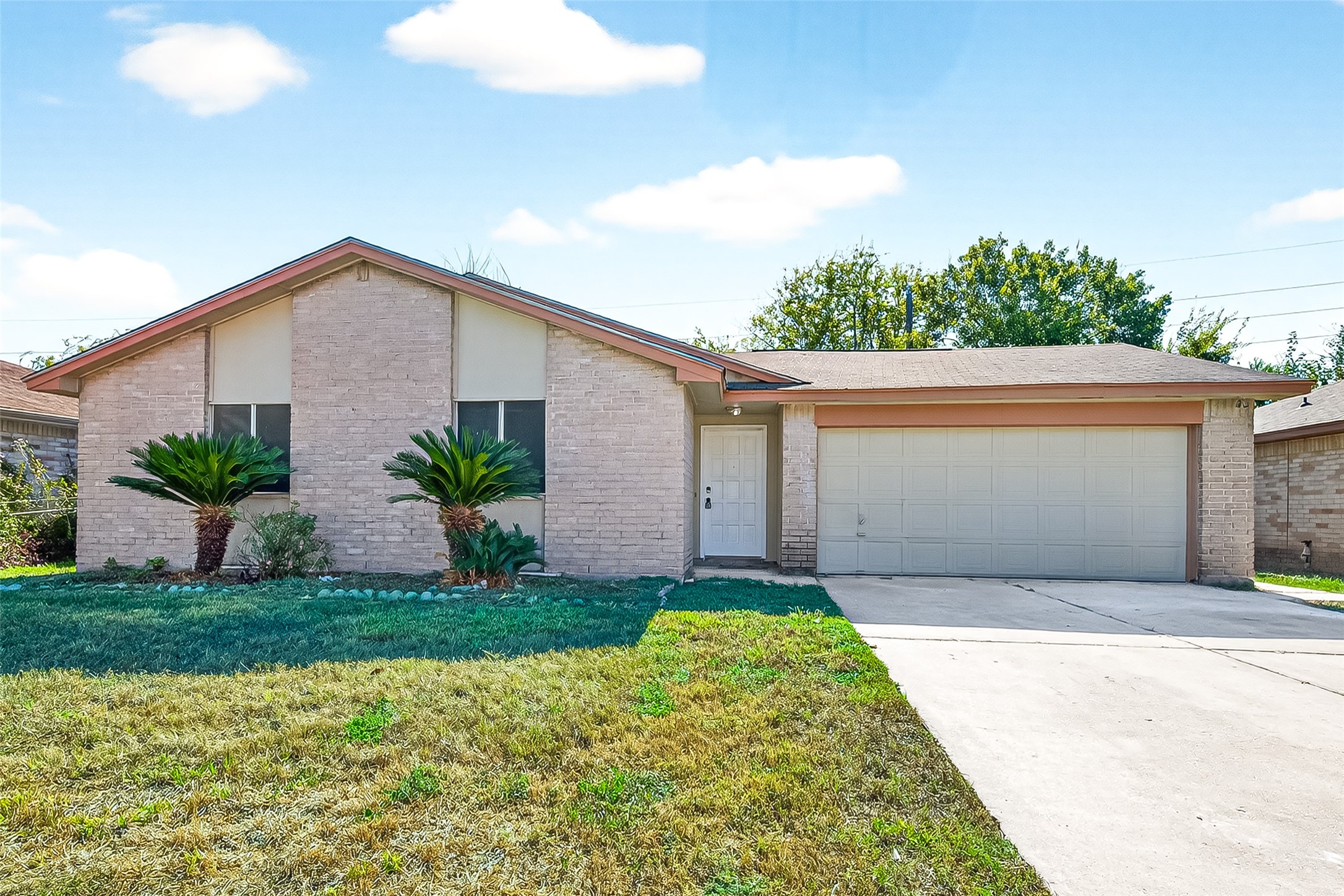 11622 Old Telegraph Road Houston, TX 77067 - Photo 5 of 38 a front view of a house with a yard and garage
