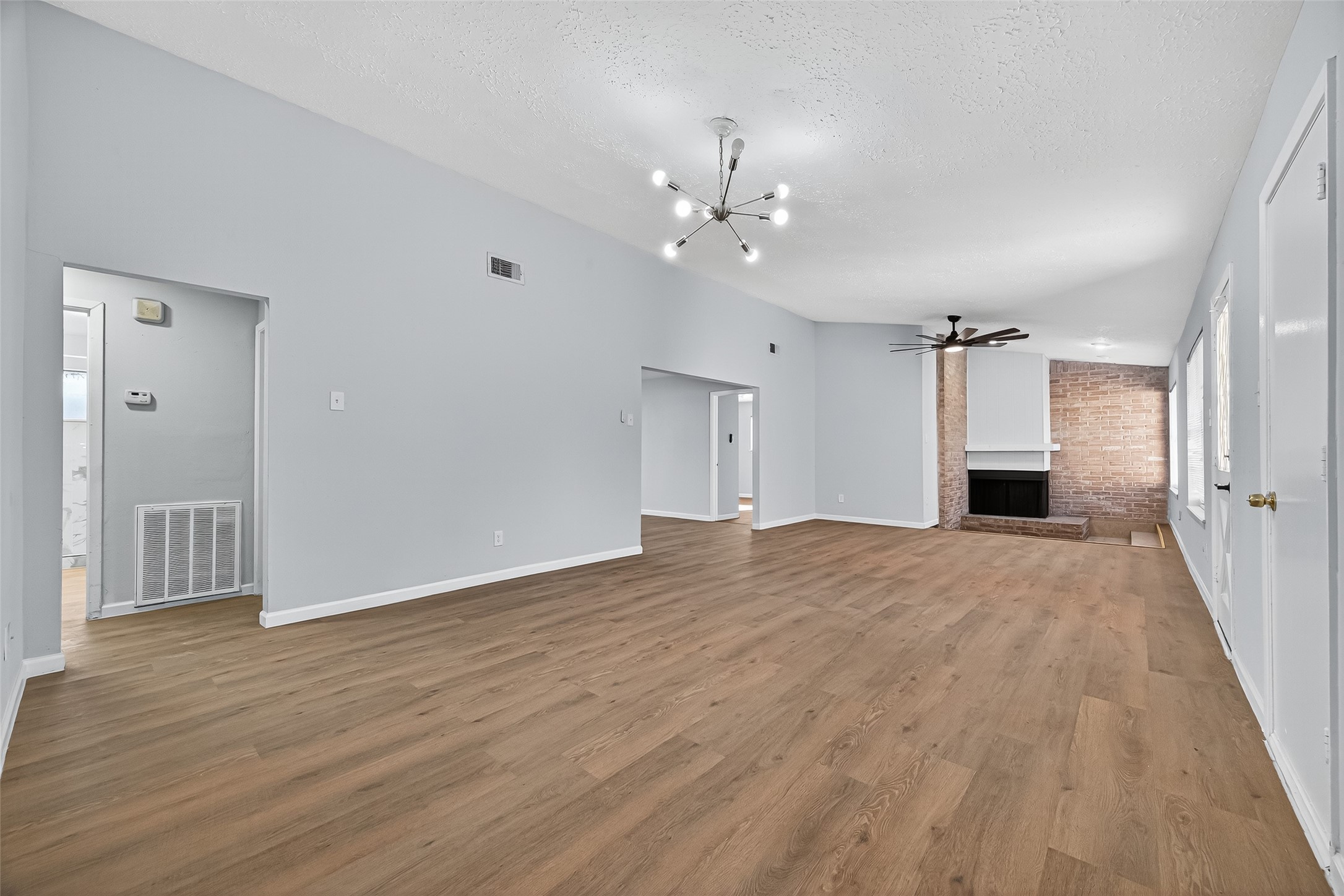 11622 Old Telegraph Road Houston, TX 77067 - Photo 7 of 38 a view of empty room with wooden floor and fireplace