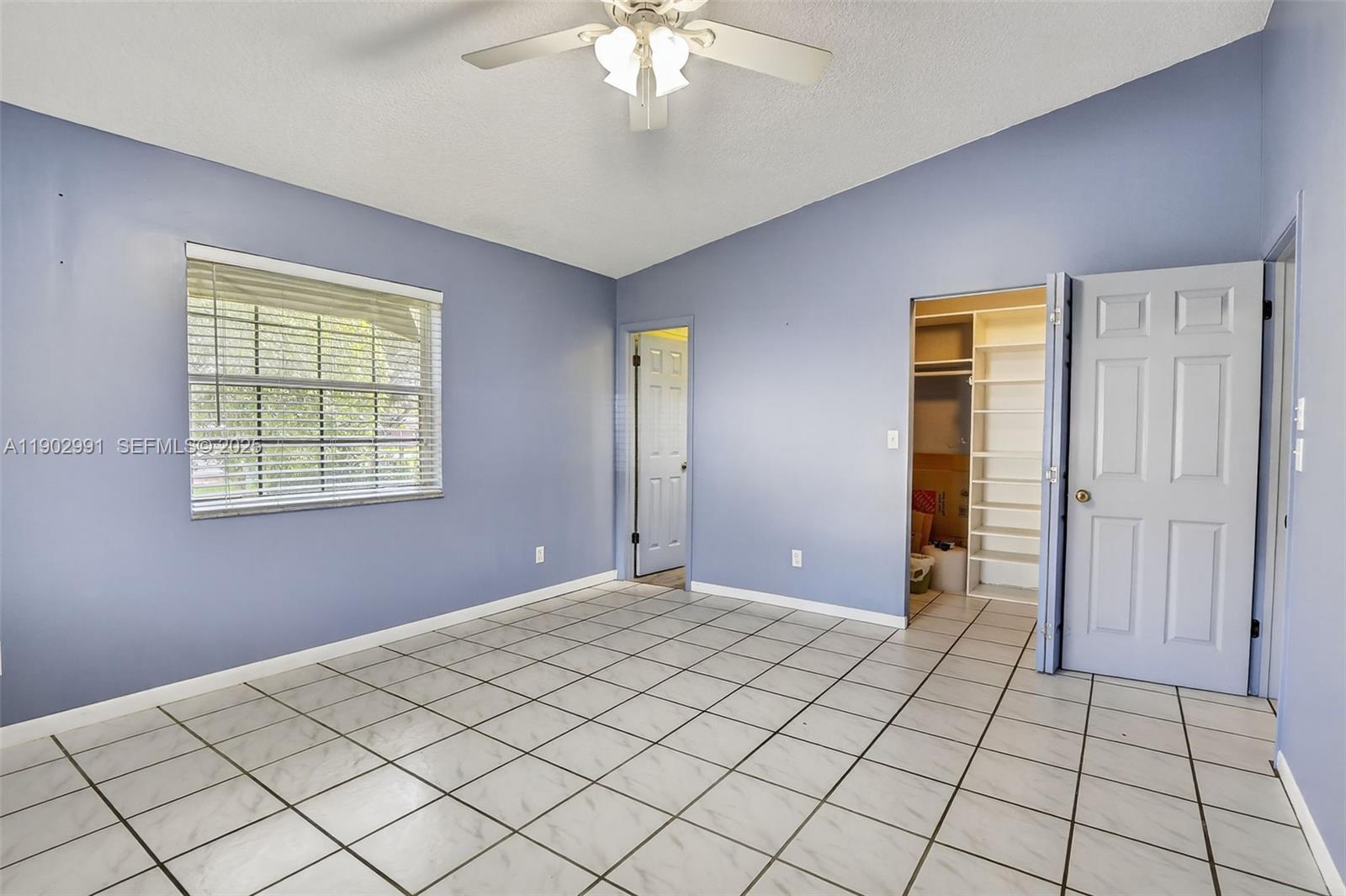 5010 Southwest 201st Terrace Southwest Ranches, FL 33332 - Photo 15 of 50 a view of an empty room with window and chandelier fan