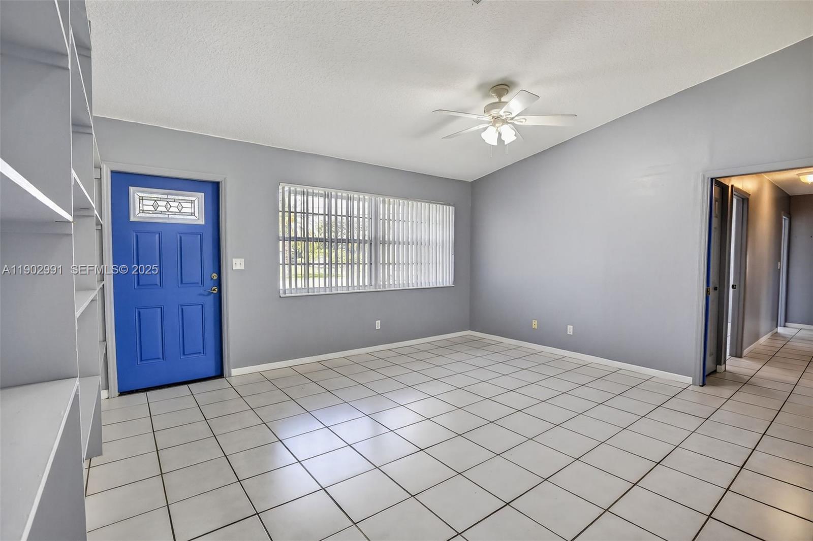 5010 Southwest 201st Terrace Southwest Ranches, FL 33332 - Photo 9 of 50 a view of an empty room with a chandelier fan and window