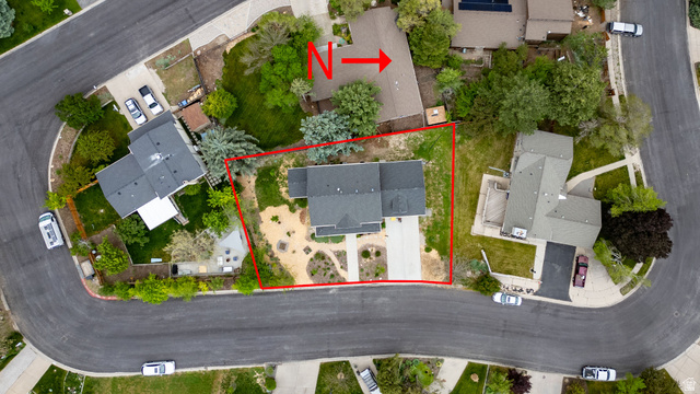1552 Sumac Drive Logan, UT 84321 - Photo 58 of 72 Aerial view of a residential property on a curved street, featuring a grey-roofed dwelling with a paved driveway