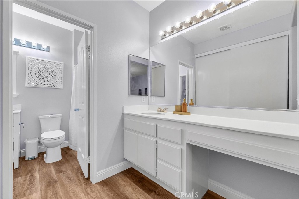 11499 Bridgeway Drive Riverside, CA 92505 - Photo 27 of 70 a bathroom with a sink a toilet and a mirror