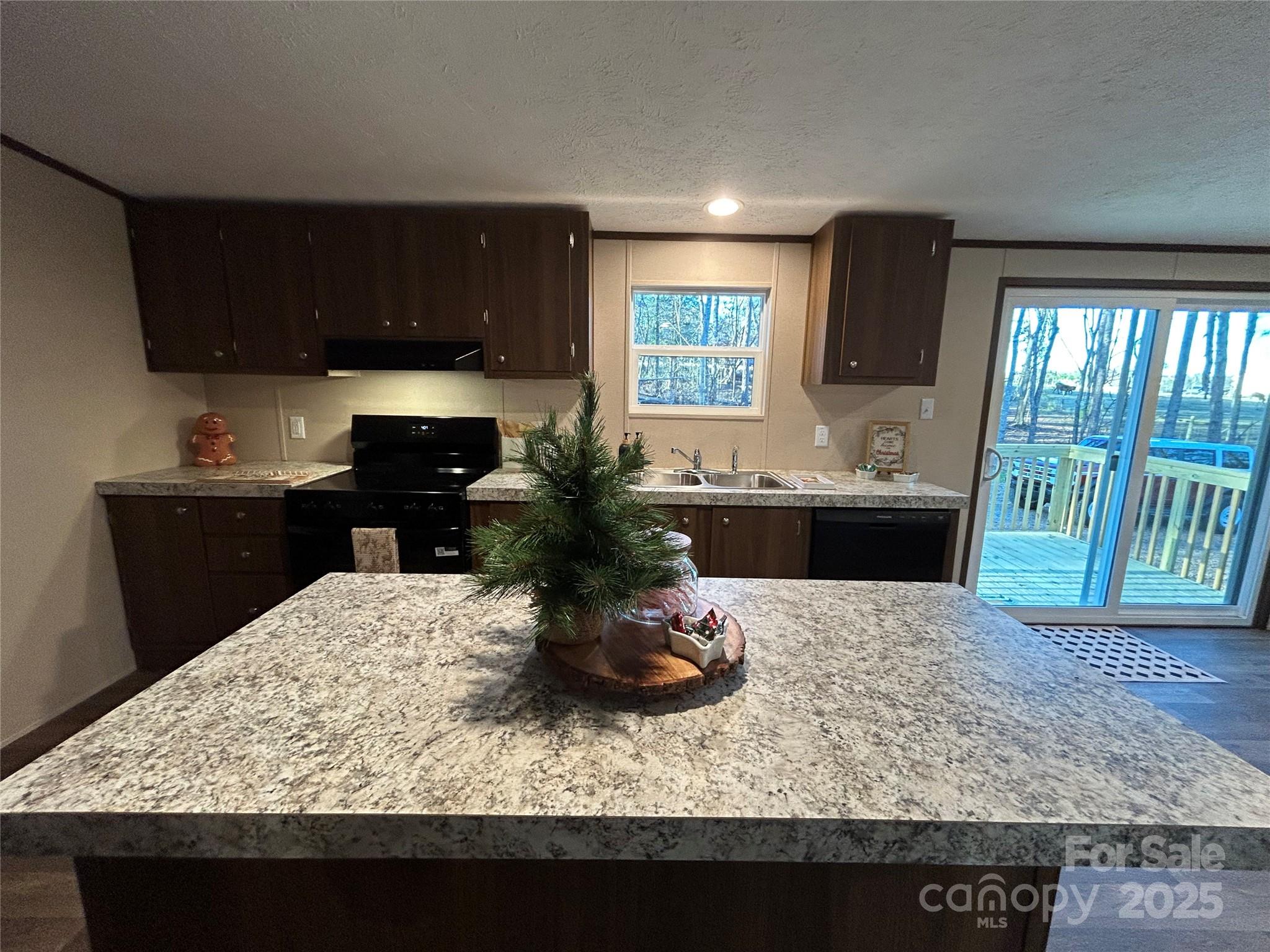 3336 Cliffside Road Mooresboro, NC 28114 - Photo 25 of 29 a kitchen with a sink and wooden cabinets