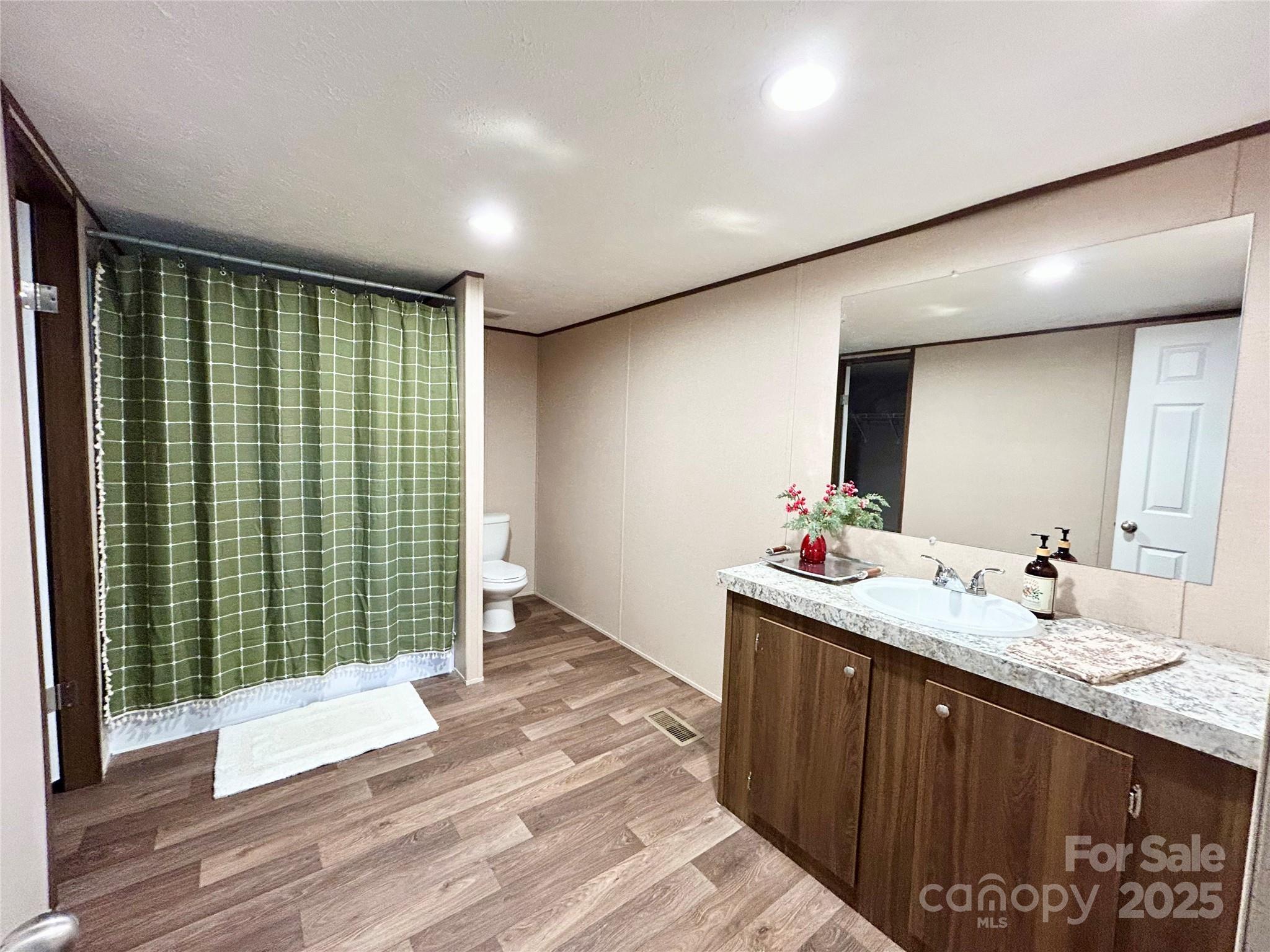3336 Cliffside Road Mooresboro, NC 28114 - Photo 7 of 29 a bathroom with a double vanity sink and a mirror