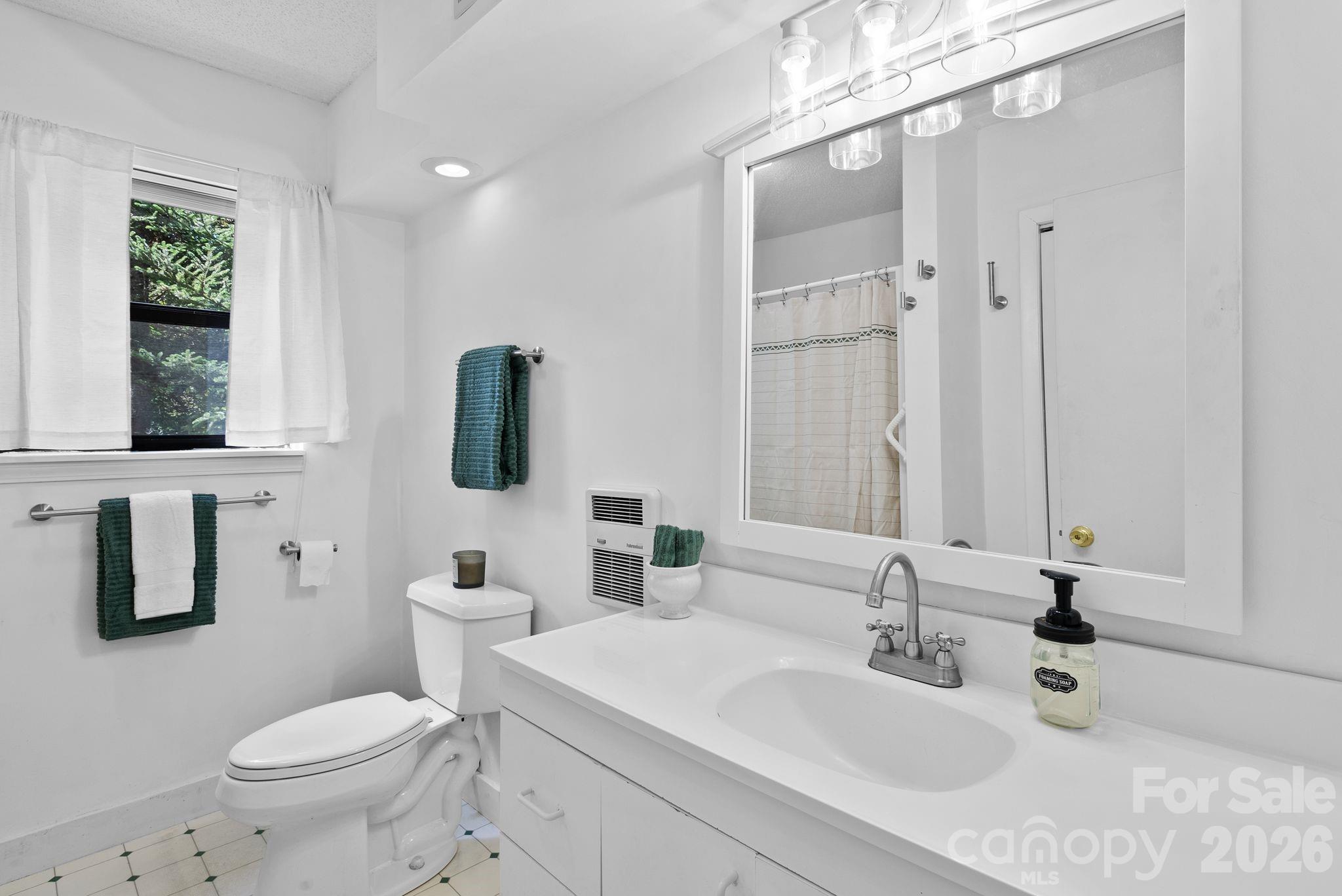 53 Hackberry Lane Waynesville, NC 28785 - Photo 22 of 40 a bathroom with a sink toilet tub and shower