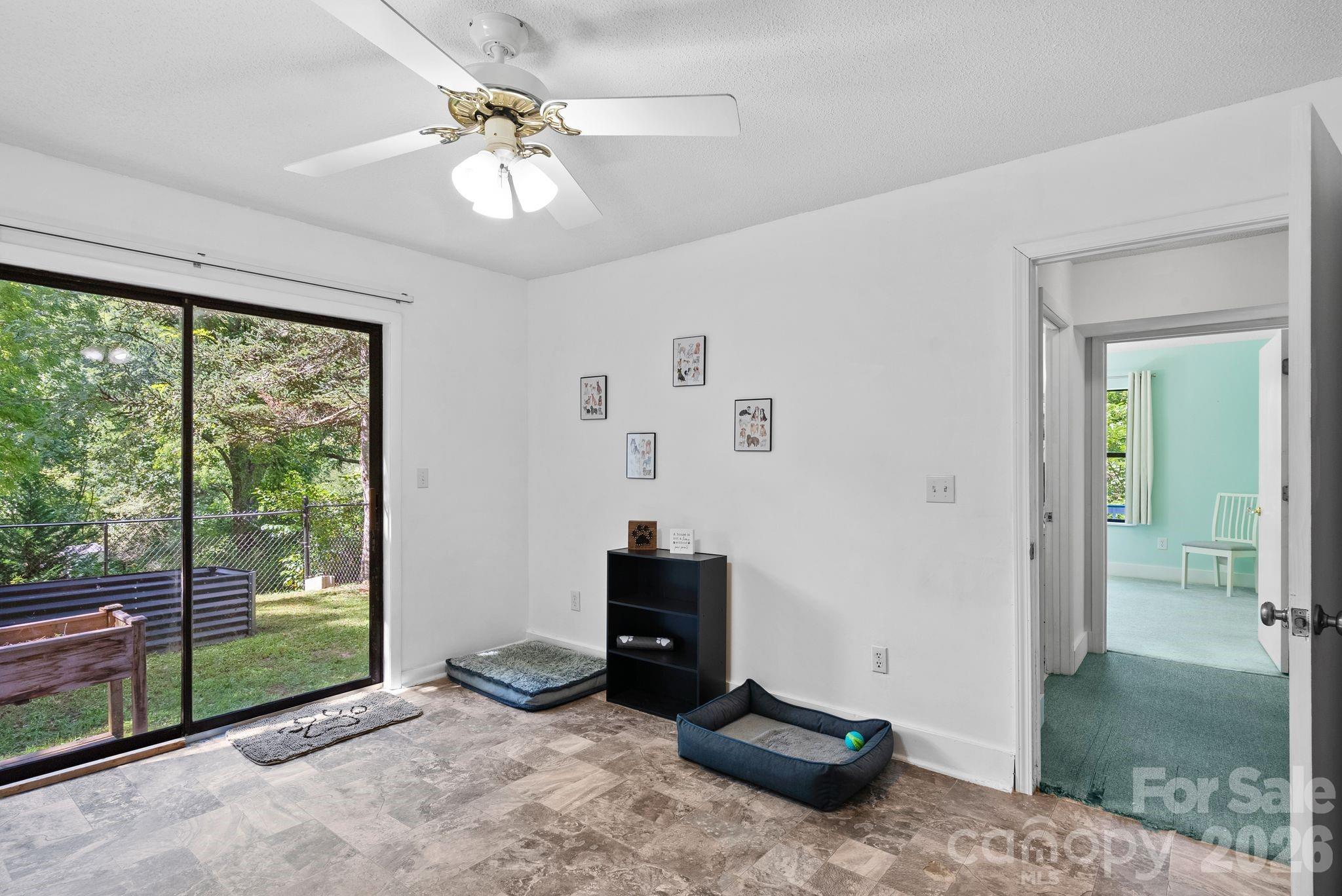 53 Hackberry Lane Waynesville, NC 28785 - Photo 24 of 40 a bedroom with a bed and a chandelier
