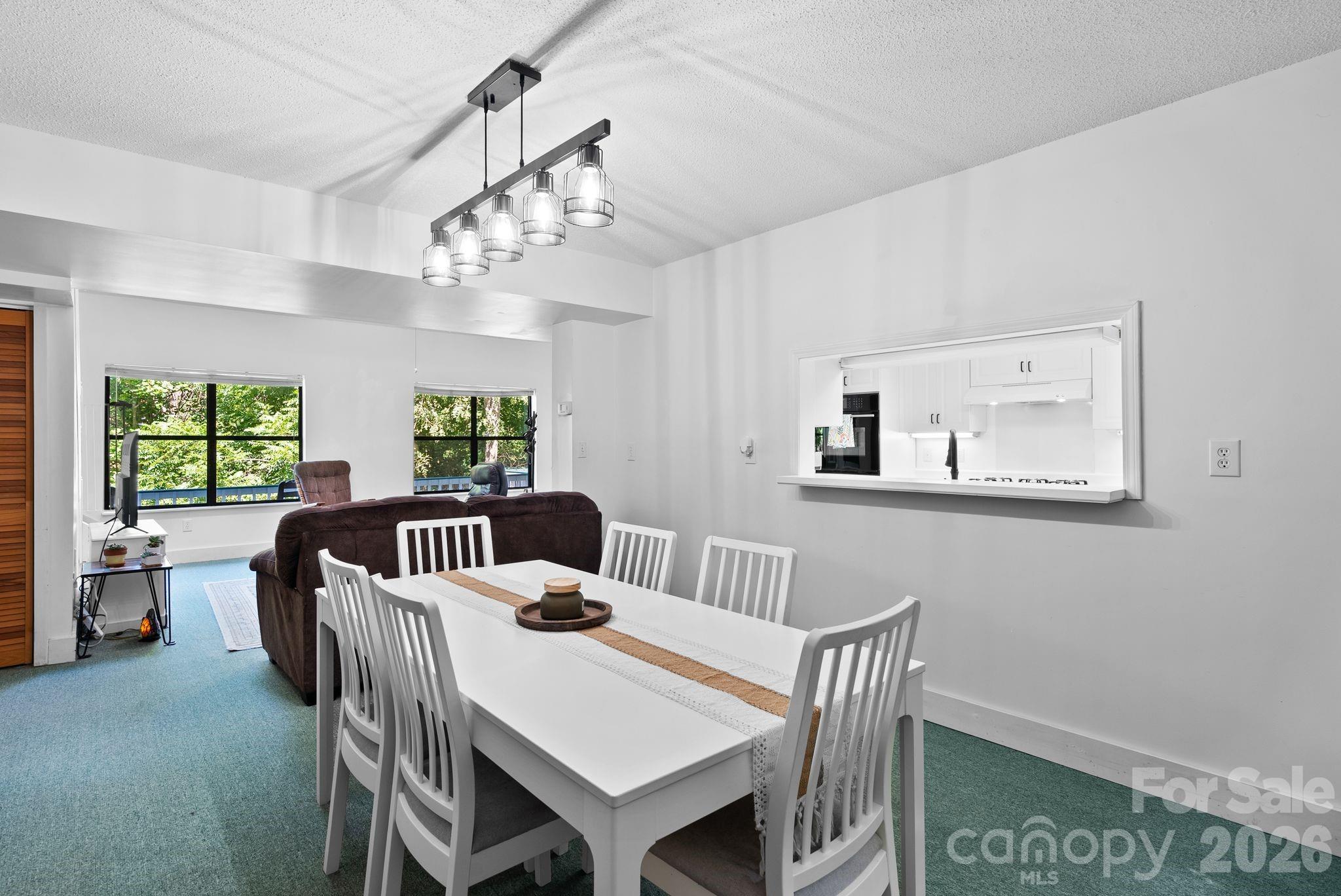 53 Hackberry Lane Waynesville, NC 28785 - Photo 25 of 40 a view of a dining room with furniture window and outside view