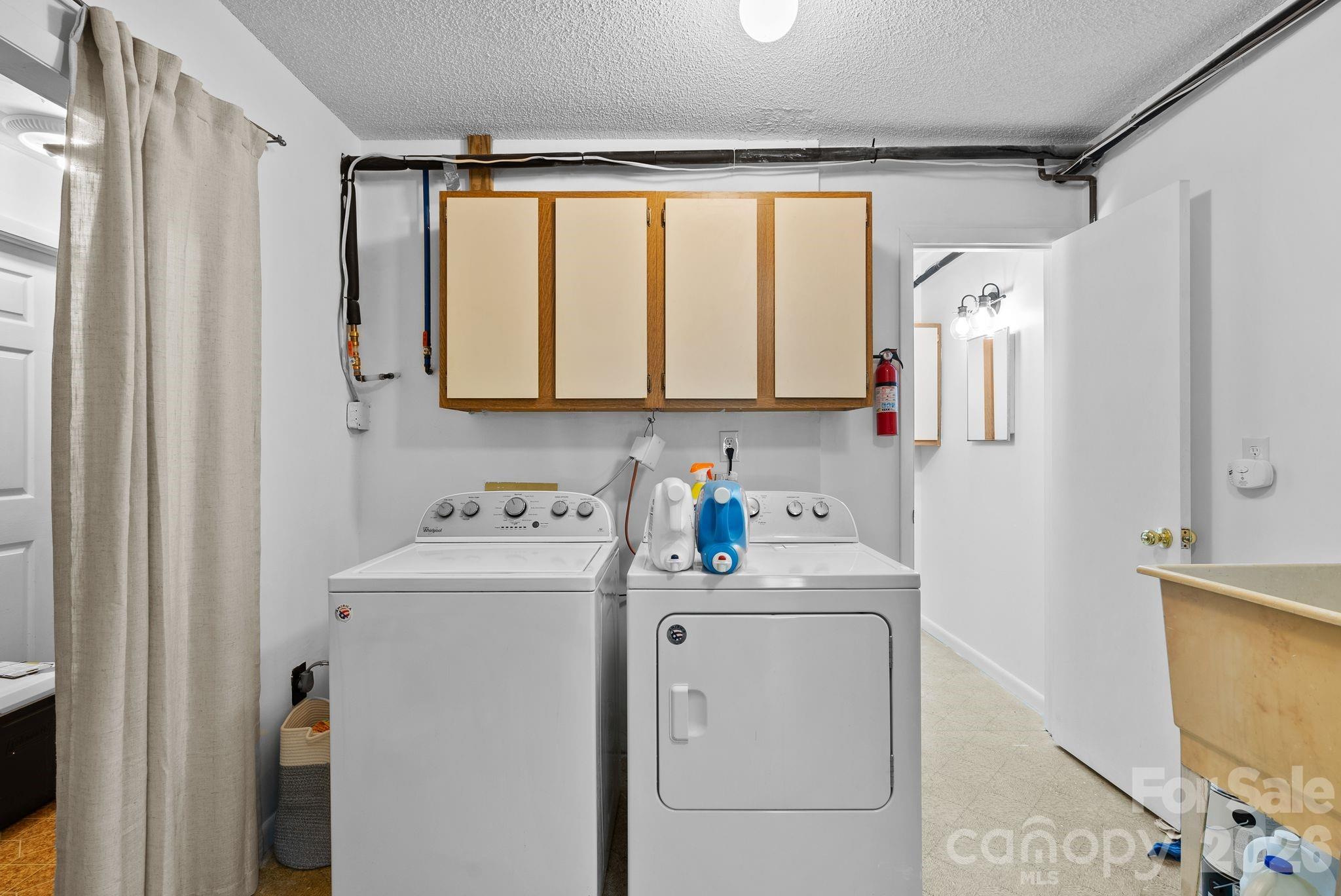 53 Hackberry Lane Waynesville, NC 28785 - Photo 29 of 40 a bathroom with a sink a washer and dryer