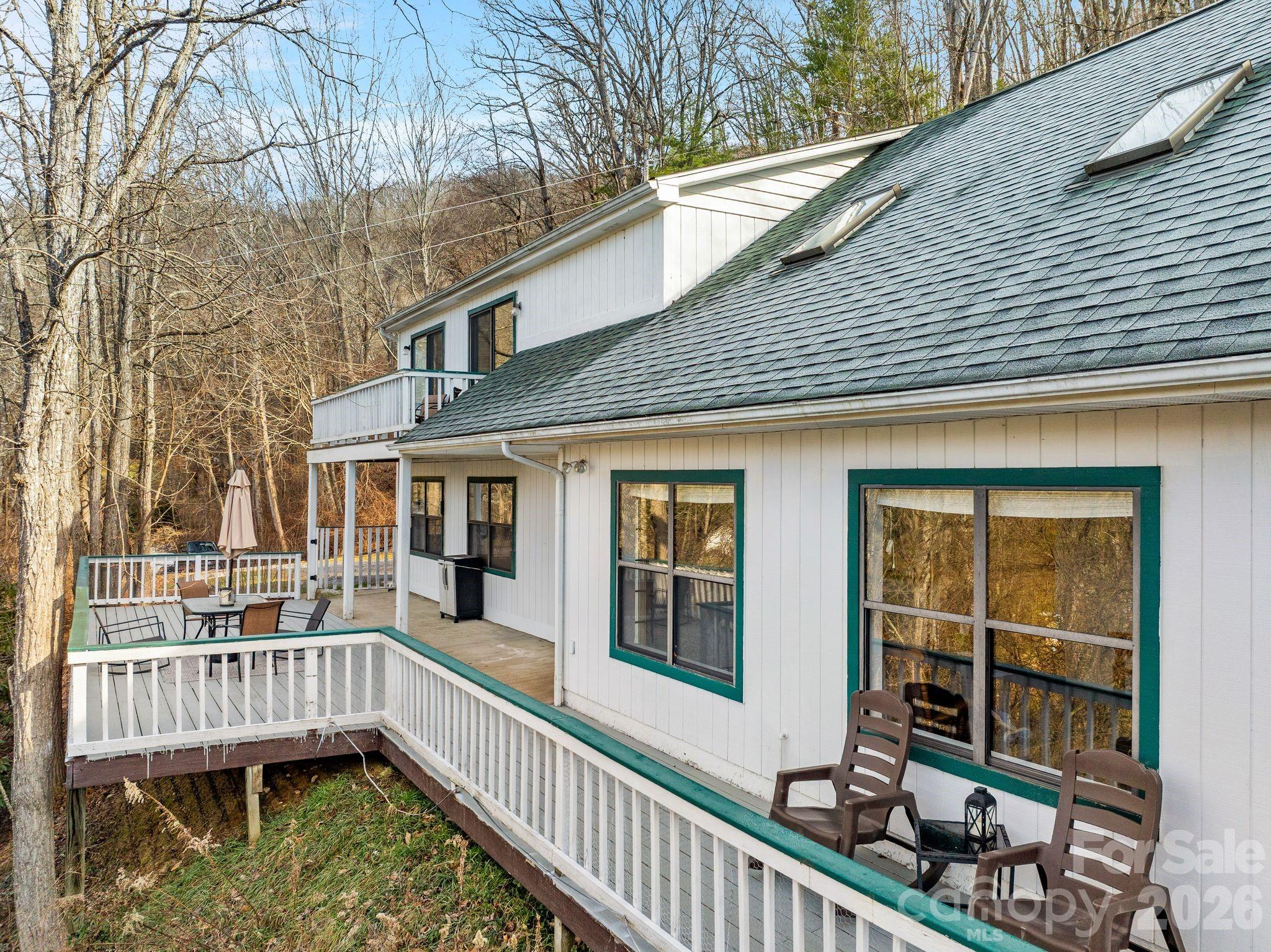 53 Hackberry Lane Waynesville, NC 28785 - Photo 33 of 40 a view of a house with large windows and wooden fence