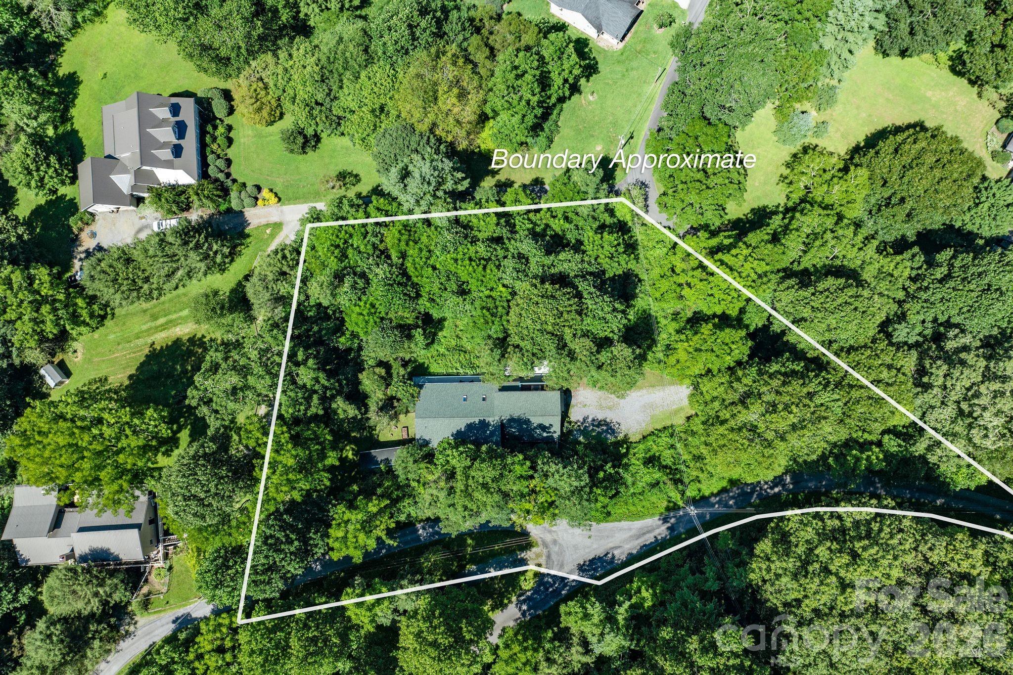 53 Hackberry Lane Waynesville, NC 28785 - Photo 10 of 40 an aerial view of a house and trees all around