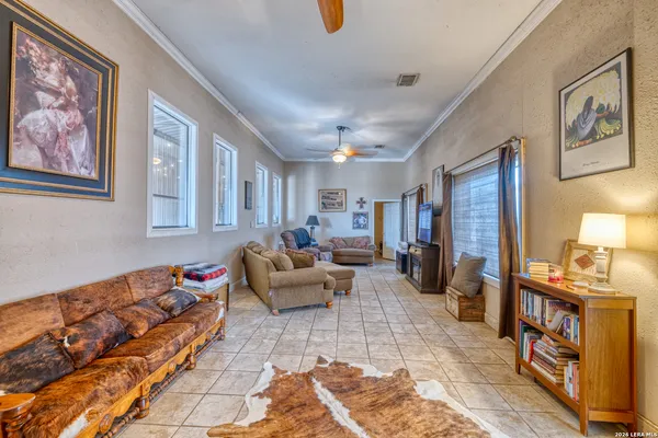 a bedroom with a bed a rug and gym equipment