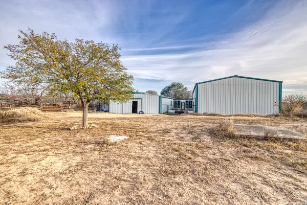 a spacious bedroom with a bed and a chandelier