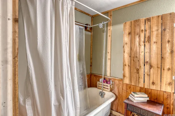 a living room with a large window a table and chairs