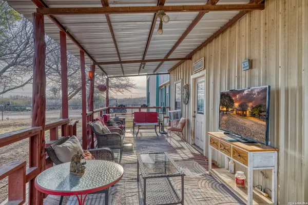 a living room with a large window a table and chairs