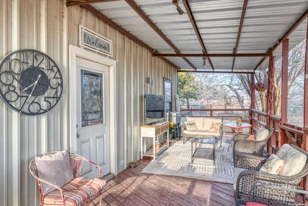 a view of a chair and table in the balcony