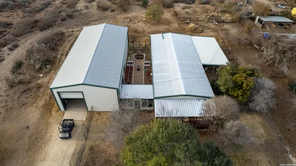 an aerial view of a house with a yard