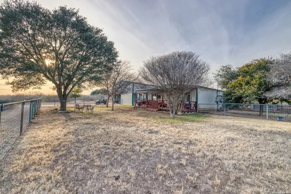 a view of a yard with large trees