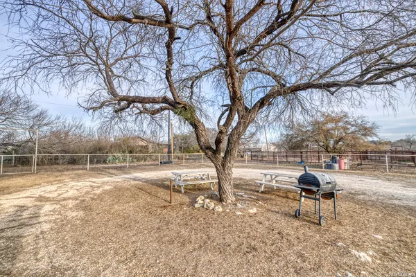 a view of a yard with wooden fence