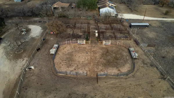an aerial view of a house with a yard and balcony
