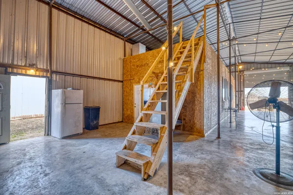 a view of a hallway with wooden floor and fence