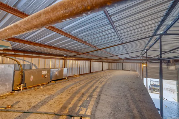 a spacious bedroom with a bed and a chandelier