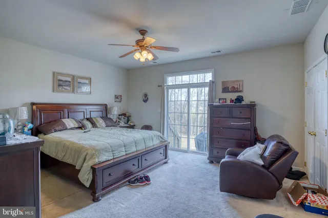 a spacious bedroom with a bed and a chandelier