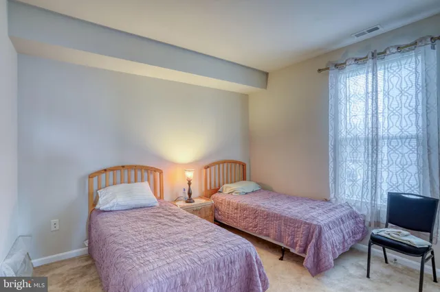 a bedroom with two beds and a window