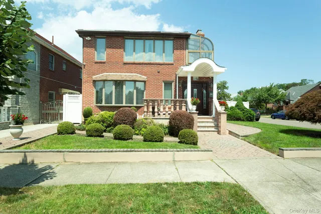 a front view of a house with garden