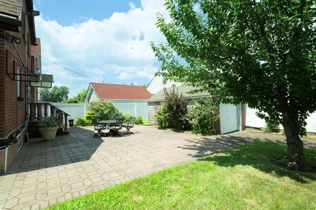 a view of a backyard with sitting area