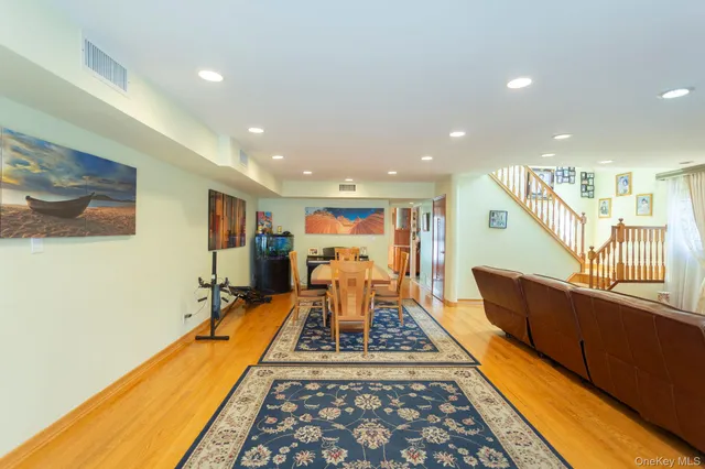 a living room with furniture rug and wooden floor