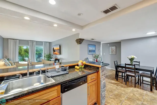 a kitchen with stainless steel appliances a refrigerator and a stove top oven