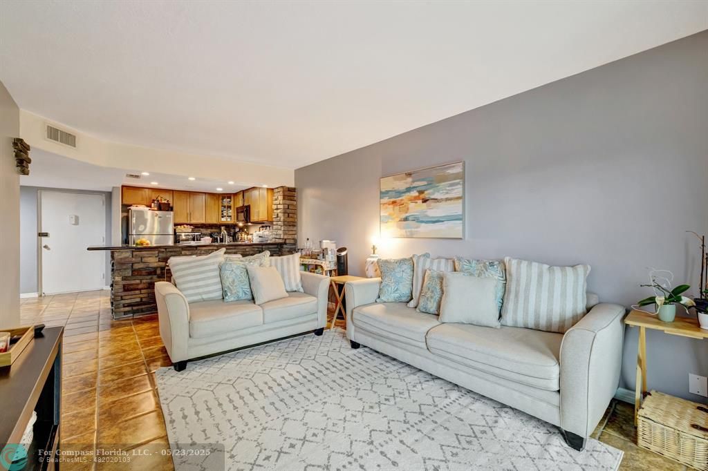 3004 Northeast 5th Terrace, Unit 208C Wilton Manors, FL 33334 - Photo 19 of 63 a living room with furniture and a couch