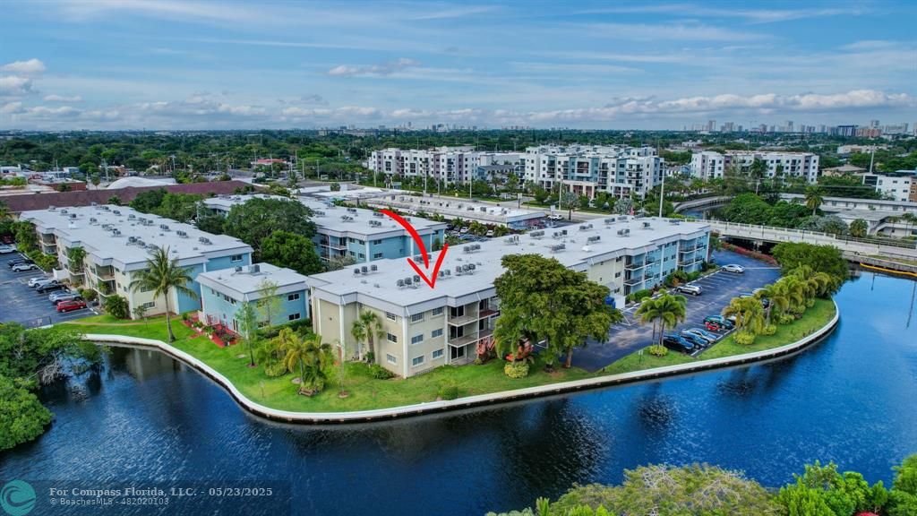 3004 Northeast 5th Terrace, Unit 208C Wilton Manors, FL 33334 - Photo 2 of 63 an aerial view of a house with a garden and lake view