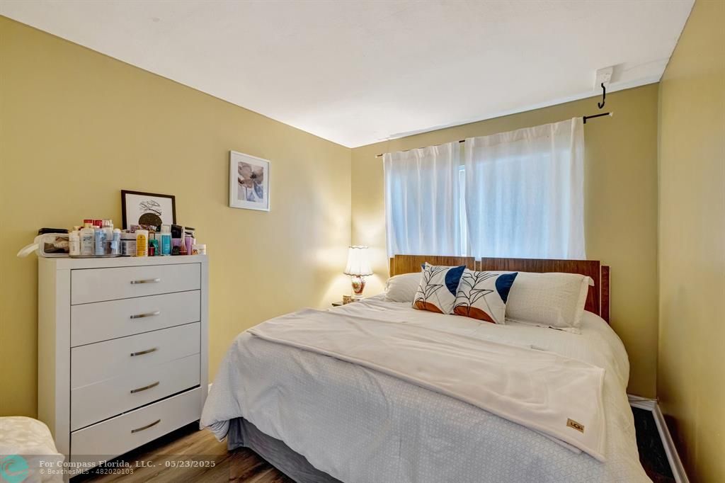 3004 Northeast 5th Terrace, Unit 208C Wilton Manors, FL 33334 - Photo 21 of 63 a bedroom with a bed and a dresser