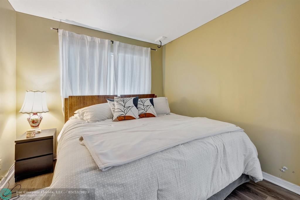 3004 Northeast 5th Terrace, Unit 208C Wilton Manors, FL 33334 - Photo 22 of 63 a bedroom with a bed and a window