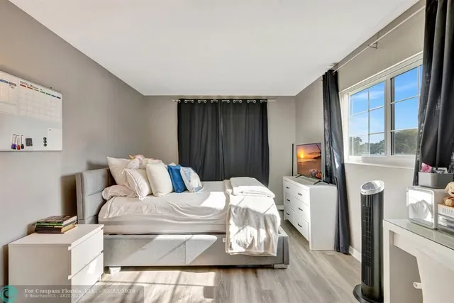 a bathroom with a sink vanity mirror and toilet