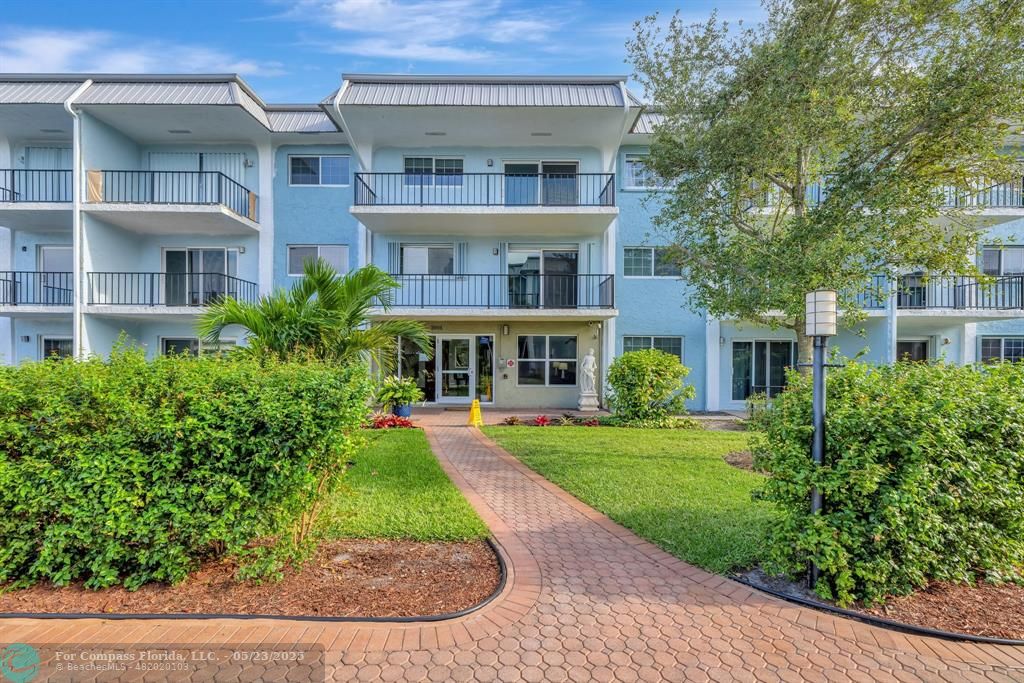 3004 Northeast 5th Terrace, Unit 208C Wilton Manors, FL 33334 - Photo 3 of 63 front view of a building with a yard