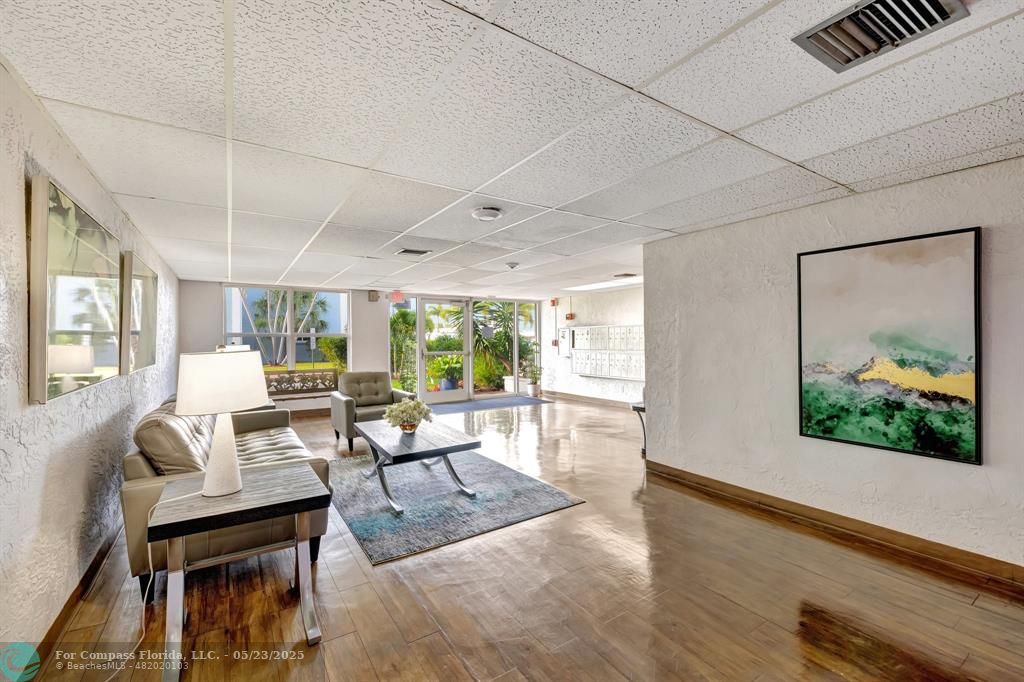 3004 Northeast 5th Terrace, Unit 208C Wilton Manors, FL 33334 - Photo 34 of 63 a living room with furniture and a large window