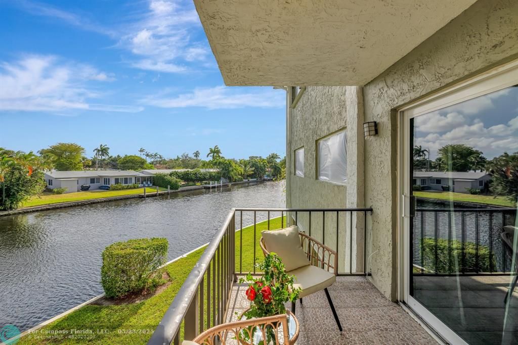 3004 Northeast 5th Terrace, Unit 208C Wilton Manors, FL 33334 - Photo 40 of 63 a view of a balcony with lake view and wooden floor