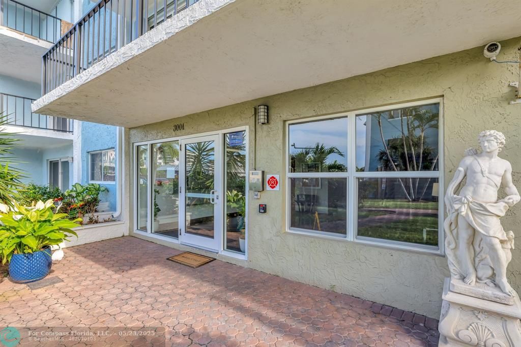 3004 Northeast 5th Terrace, Unit 208C Wilton Manors, FL 33334 - Photo 41 of 63 a view of front door and porch with seating space