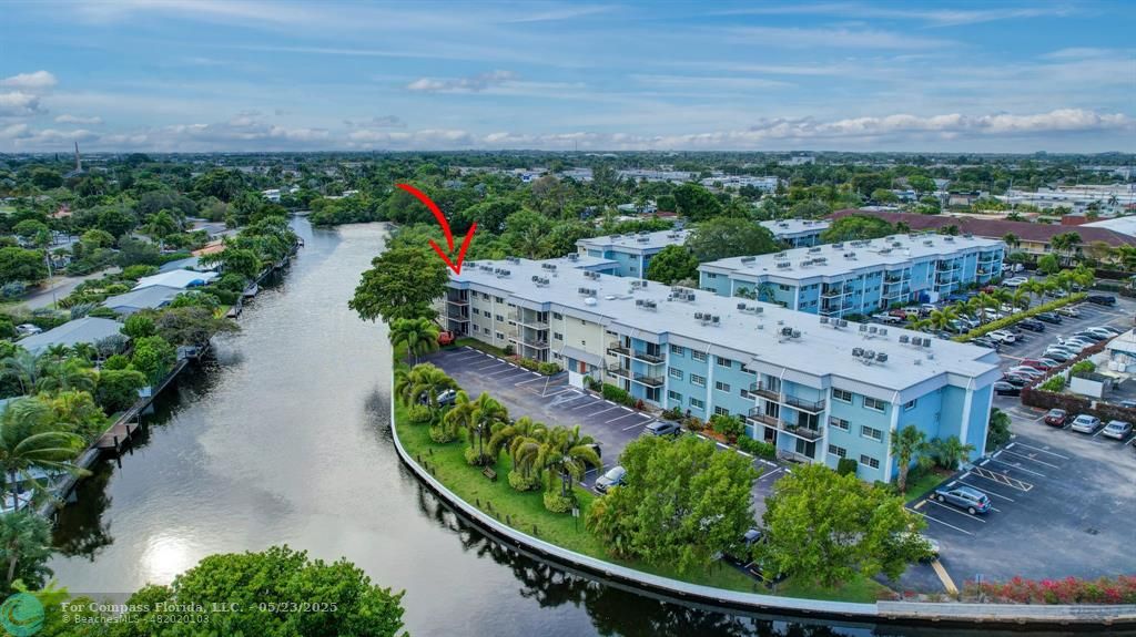3004 Northeast 5th Terrace, Unit 208C Wilton Manors, FL 33334 - Photo 54 of 63 a view of a houses with a yard and lake