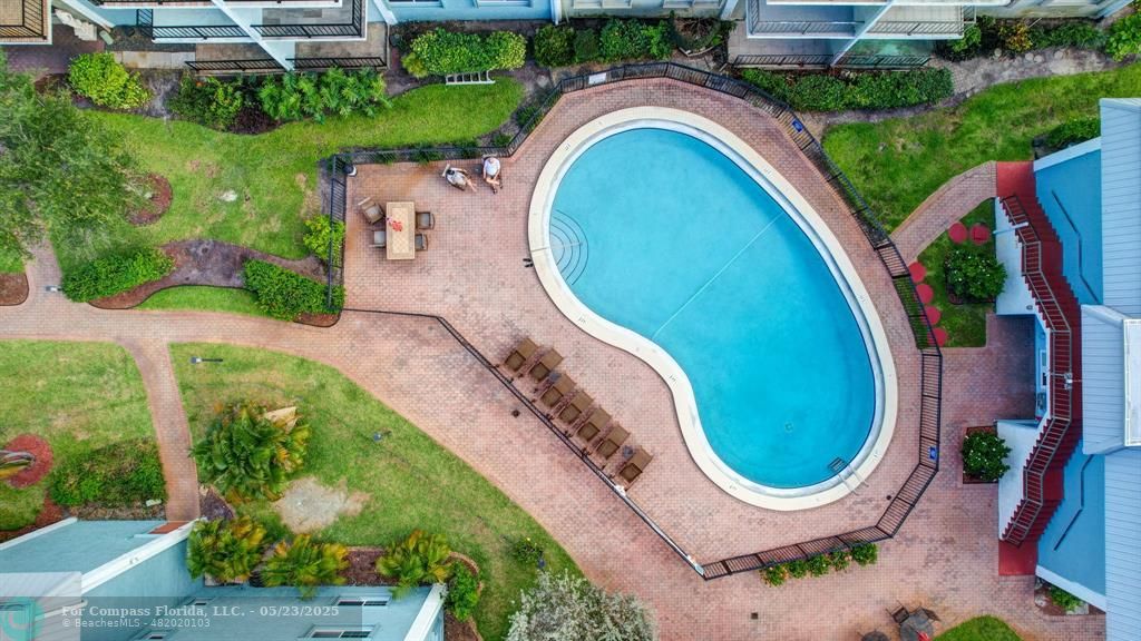 3004 Northeast 5th Terrace, Unit 208C Wilton Manors, FL 33334 - Photo 62 of 63 an aerial view of a house with swimming pool and outdoor seating