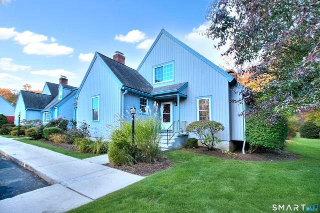 a front view of a house with a garden and plants