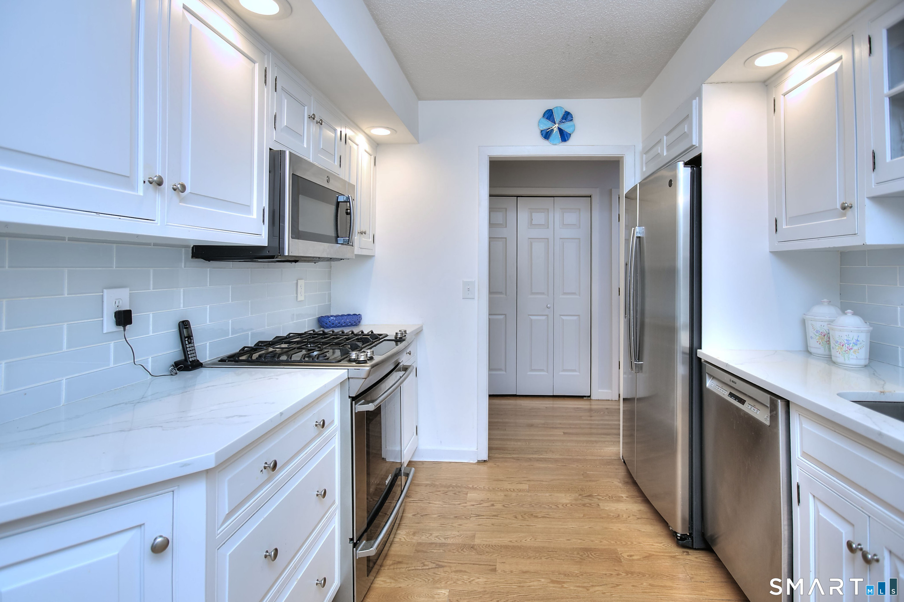 160 Glengarry Road, Unit 160 Fairfield, CT 06825 - Photo 12 of 31 a kitchen with stainless steel appliances granite countertop a sink and a stove