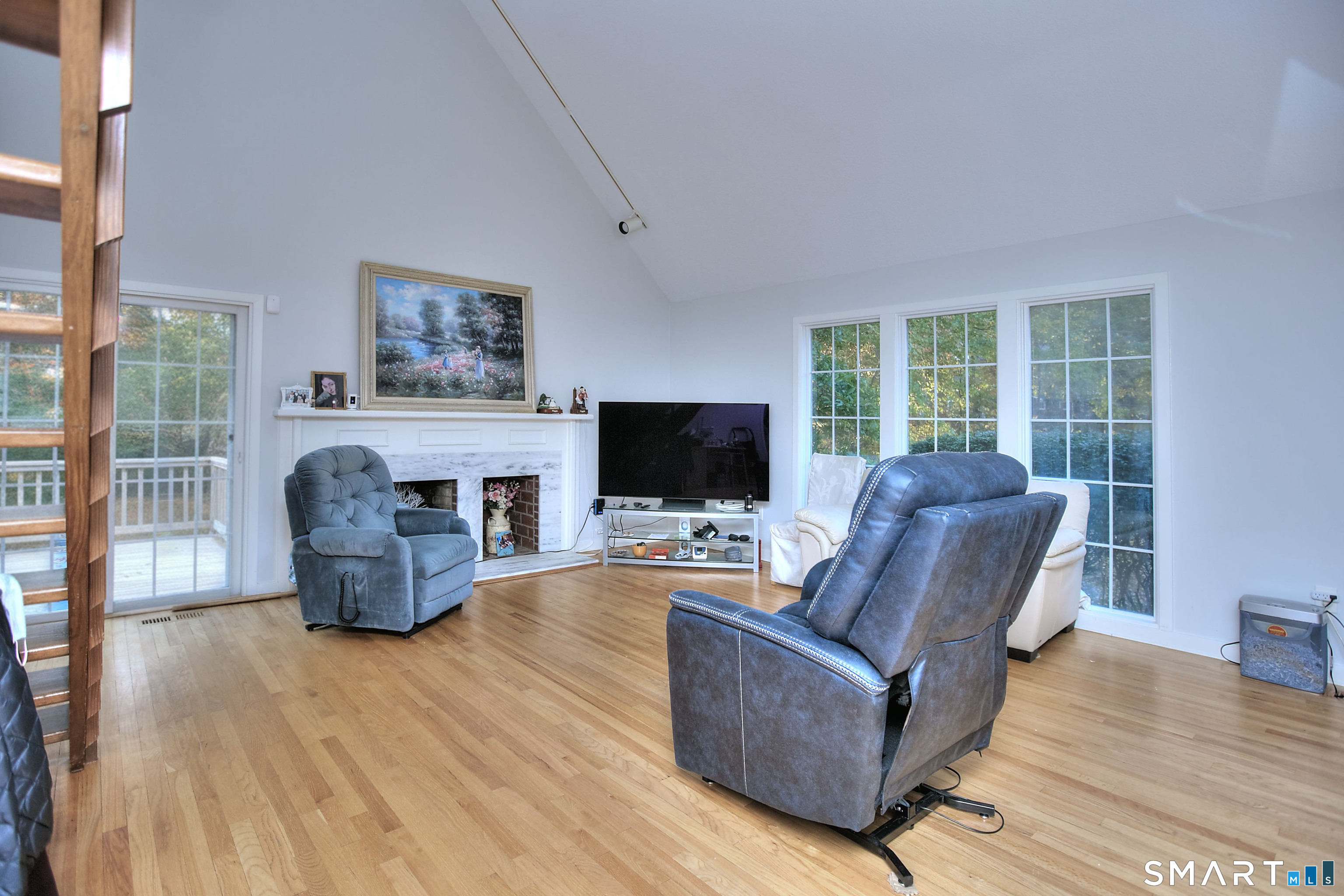160 Glengarry Road, Unit 160 Fairfield, CT 06825 - Photo 4 of 31 a living room with furniture a flat screen tv and a fireplace