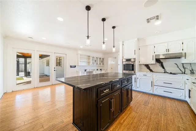 a kitchen with stainless steel appliances granite countertop a stove and a sink