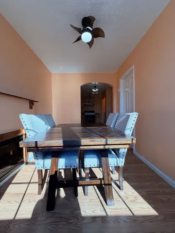 a view of a dining room with furniture and wooden floor