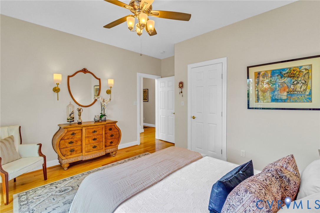 578 High Point Trail Heathsville, VA 22473 - Photo 22 of 50 a bedroom with a bed a lamp and a chandelier