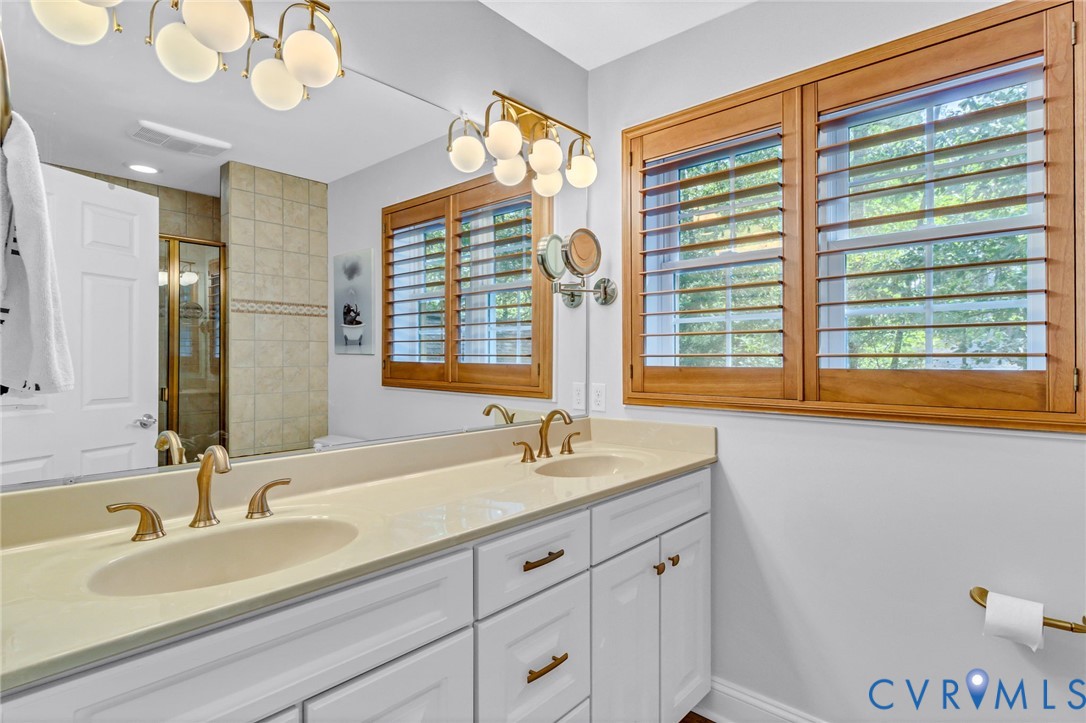 578 High Point Trail Heathsville, VA 22473 - Photo 29 of 50 a bathroom with a granite countertop sink and a large mirror