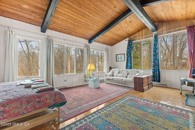 a spacious bedroom with a large bed and windows